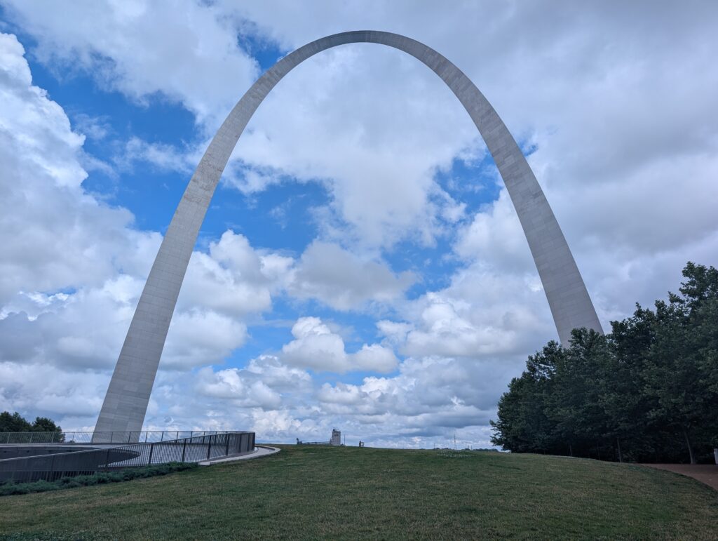 Gateway Arch in St. Louis amd the grounds with the sky in the background