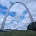 Gateway Arch in St. Louis amd the grounds with the sky in the background