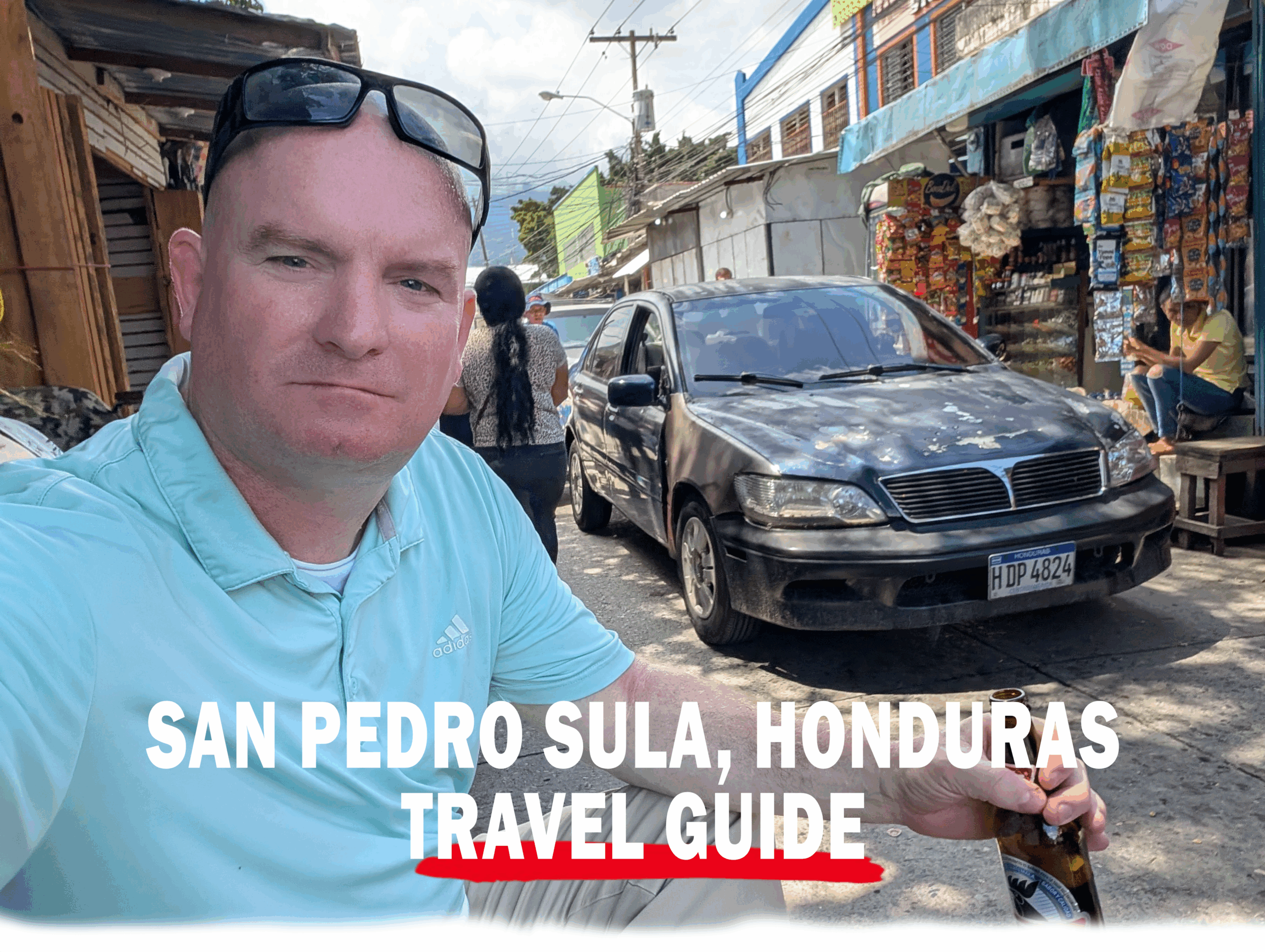 Michael McGill sits in an alley way with a beer in San Pedro Sula, Honduras