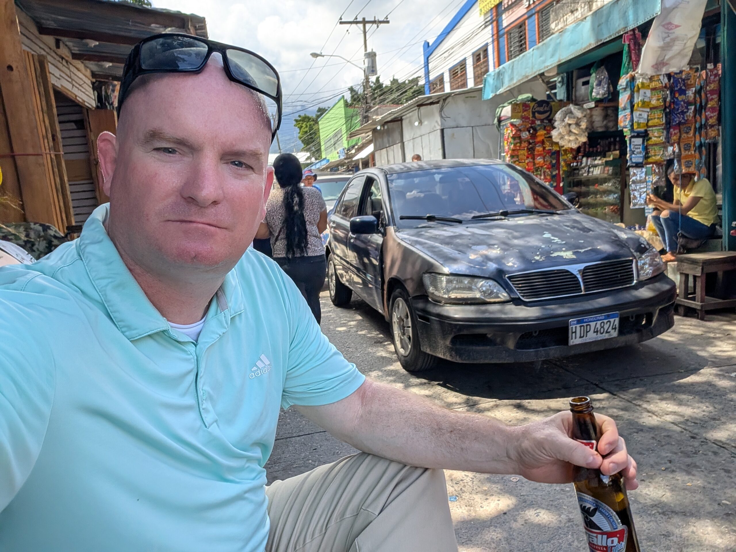 McGill Drinking Beers in Honduras Michael McGill the Traveling American sitting in a plastic chair while drinking a beer on the streets on San Pedro Sula Honduras