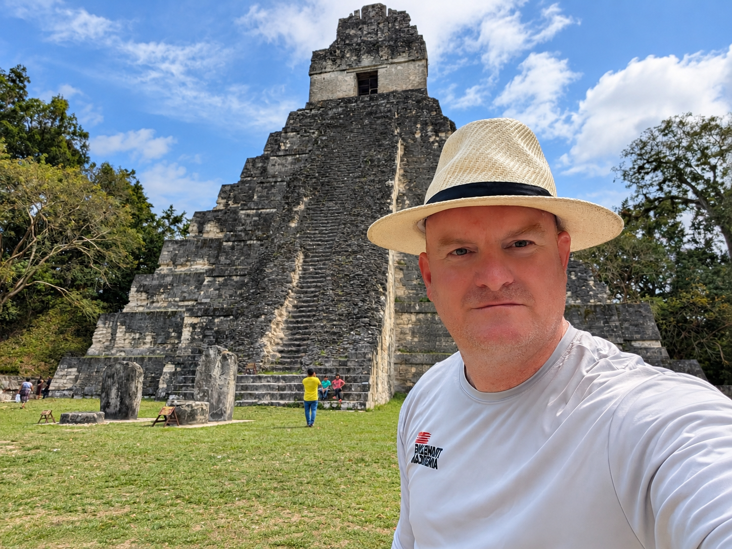 Michael McGill standing before a Maya temple during Tikal travel in Guatemala